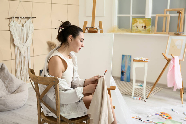 Joven artista femenina pintando en taller - Foto, Imagen