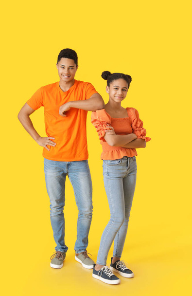 African-American brother and sister on color background - Valokuva, kuva