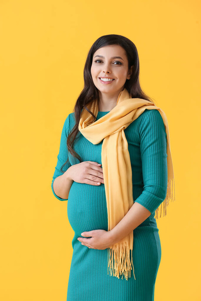 Beautiful pregnant woman on color background - Photo, image