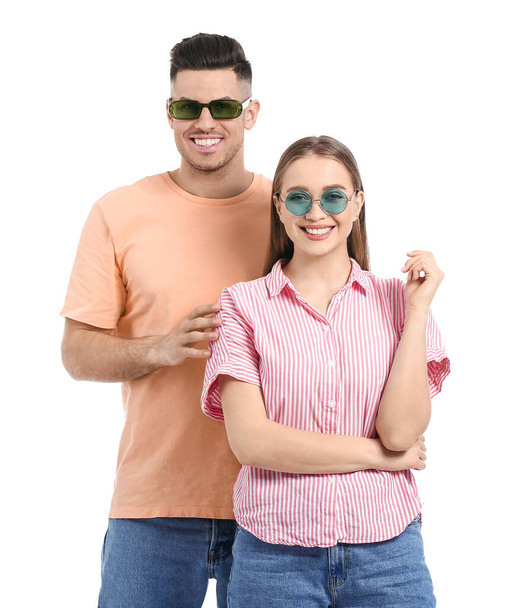 Young couple wearing stylish sunglasses on white background - Foto, Imagen