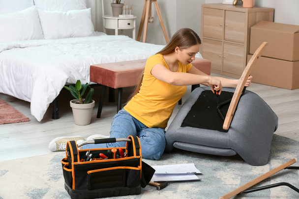 Young woman assembling furniture at home - Photo, Image