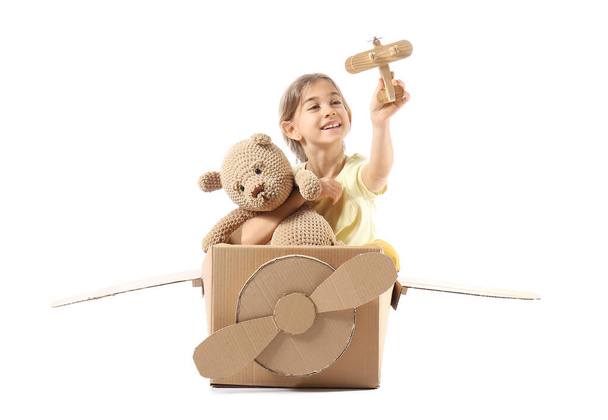 Little girl playing with toys on white background - Photo, Image