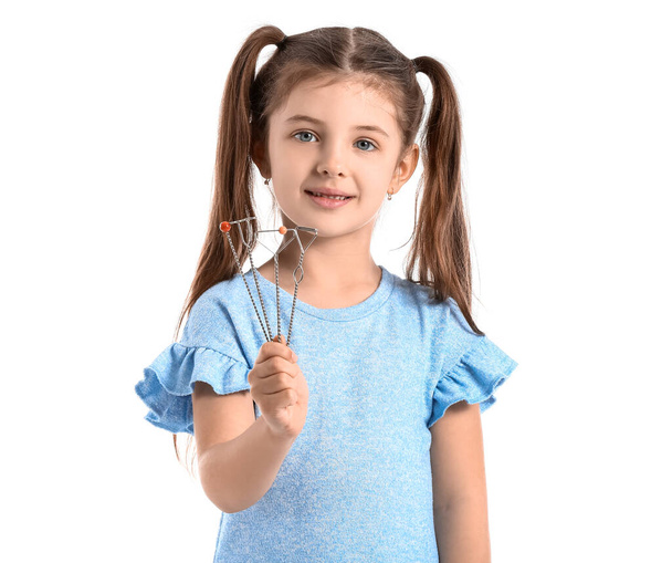 Kleines Mädchen mit logopädischen Werkzeugen zur Sprachkorrektur auf weißem Hintergrund - Foto, Bild
