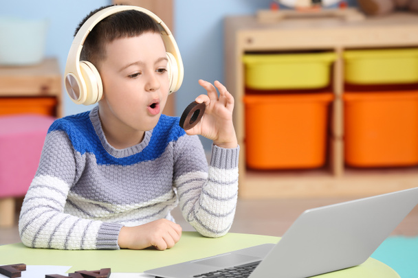 Μικρό αγόρι με εκπαίδευση φορητού υπολογιστή προφέρει γράμμα O στο σπίτι - Φωτογραφία, εικόνα