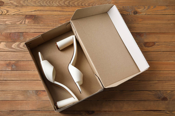Wardrobe box with shoes on wooden background - Foto, Imagem