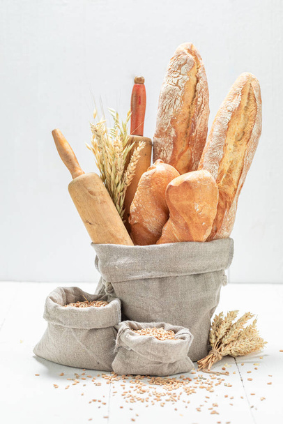 Crunchy baguettes for healthy breakfast. Made of wheat and rye. Pieces of baguette. - Photo, image