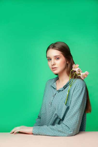 Young female model with flowers in pocket - Φωτογραφία, εικόνα