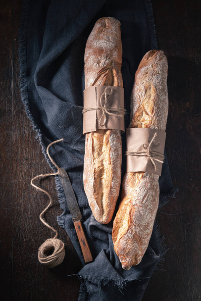 Brown baguettes for healthy breakfast. Baguettes from the bakery. Pieces of baguette. - Foto, immagini