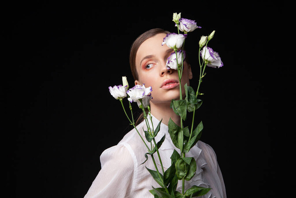 Elegant young female model with delicate flowers - Foto, Imagem