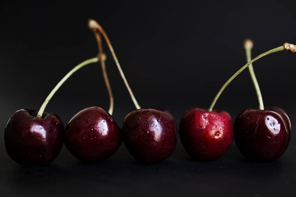 Few Dark Sweet Cherries On Dark Background.  - Foto, Bild