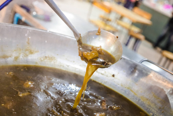 fish maw soup pouring into a pot - Photo, Image