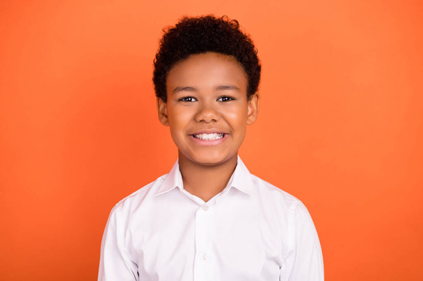Photo of young cheerful african school boy happy positive smile learning study isolated over orange color background - Foto, Bild