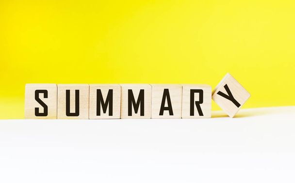 SUMMARY word on wooden cubes and white and yellow background - Photo, Image
