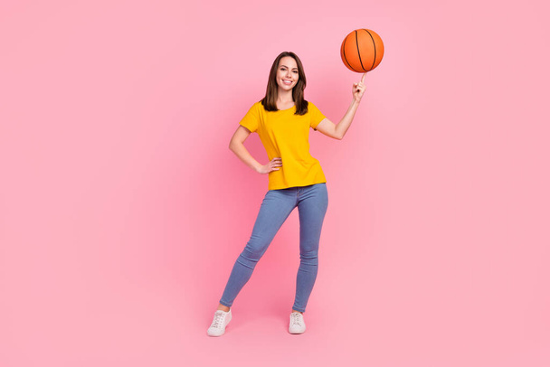 Full body photo of brunette hair young lady play baskerball wear jeans t-shirt isolated on pink color background - 写真・画像