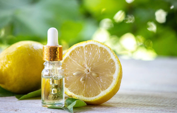 A bottle of lemon essential oil is an alternative medicine. Selective focus - Foto, Imagem