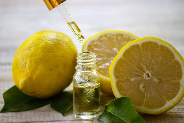 A bottle of lemon essential oil is an alternative medicine. Selective focus - Foto, immagini