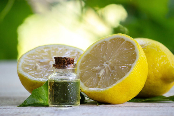 A bottle of lemon essential oil is an alternative medicine. Selective focus - Foto, imagen