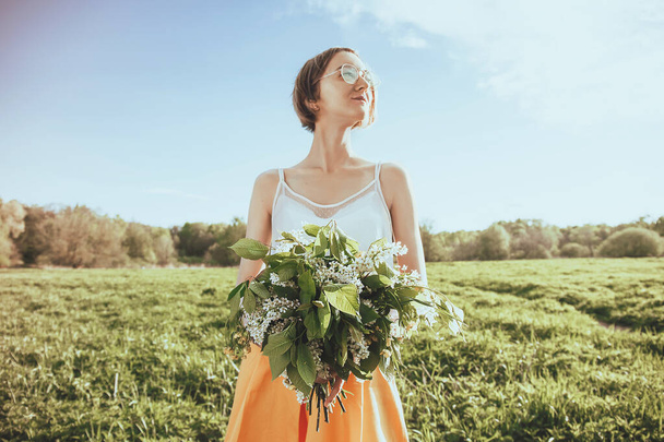 Pretty female hands holding bouquet of wildflowers. Portrait of girl with flowers. Summer background - Φωτογραφία, εικόνα