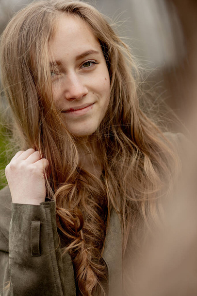 Portrait of young beautiful girl in outdoors. - Φωτογραφία, εικόνα