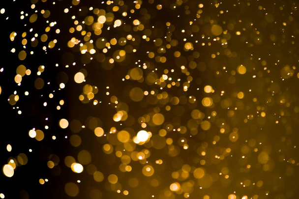 Niewyraźny widok na piękne lampki świąteczne, efekt bokeh. Piękny Złoty Kolor Bokeh Efekt. błyszczące światła grunge tło, brokat rozproszone abstrakcyjne Twinkly Światła i Gwiazdy Christmas tło. - Zdjęcie, obraz