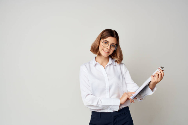 woman in white shirt documents work success studio - Фото, изображение