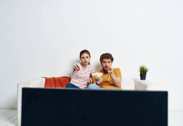 cheerful young couple watching a movie family recreation popcorn - Photo, Image