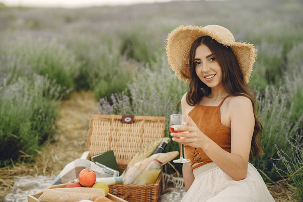 Woman in a straw hat in a lavender field - Фото, изображение