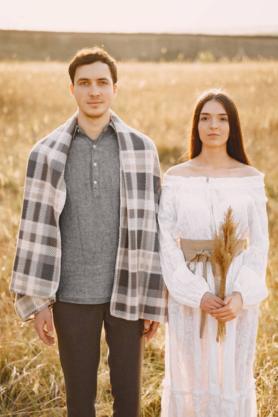 Happy couple in love in wheat field at sunset - Foto, immagini