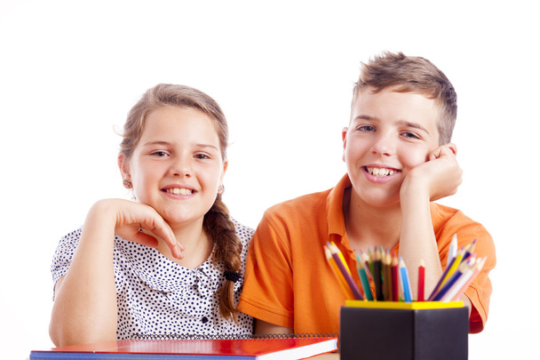 Two school kids at desk - Фото, изображение