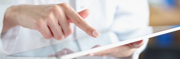 Medical officer doctor points his finger at tablet - Фото, изображение
