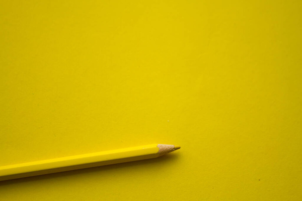 Yellow pencil on yellow background with copy space - Zdjęcie, obraz