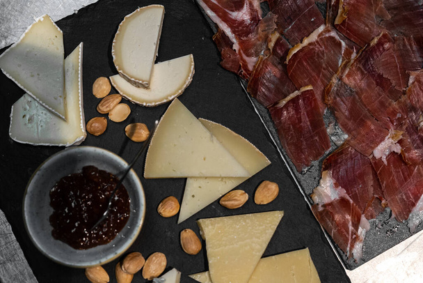 A top view of cheese and meat platters - Фото, изображение