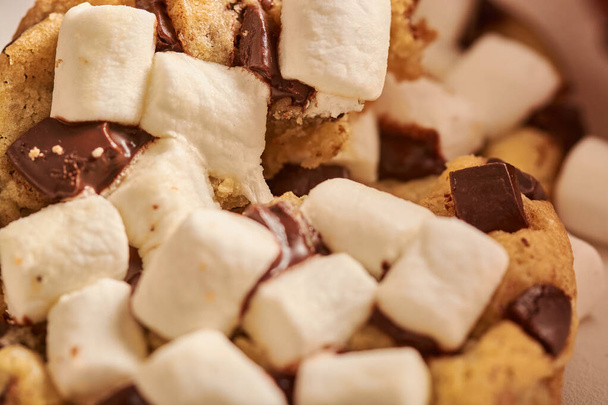A closeup of marshmallows on a chocolate chip cookie. Horizontal shot. - 写真・画像