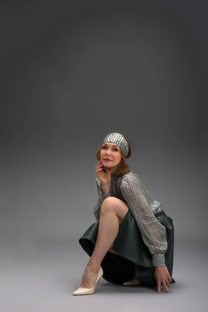 full length portrait of a fashionable aged woman isolated on grey - Fotó, kép
