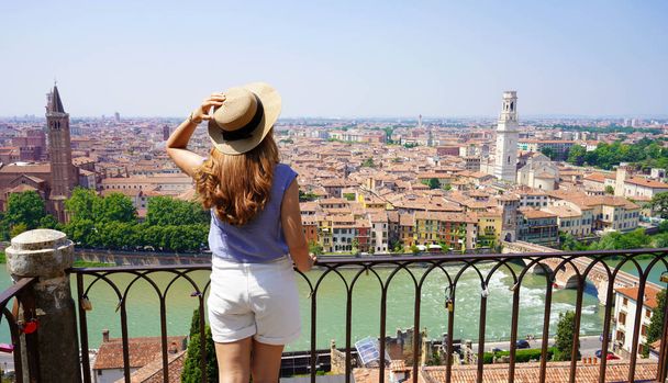 Beautiful stylish woman on balcony enjoying cityscape of Verona. Panoramic banner with happy girl on terrace in Verona, Italy. - Φωτογραφία, εικόνα