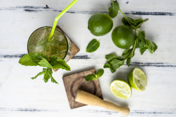 A top view shot of a fresh, cold cocktail with mint and lime - 写真・画像