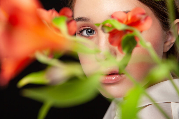 Elegant young female model with delicate flowers - Fotografie, Obrázek