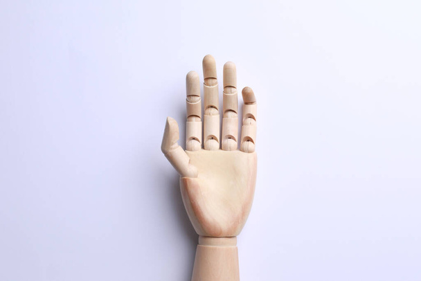 Wooden mannequin hand on white background, top view - Photo, Image