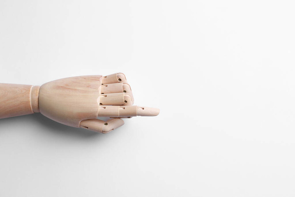 Wooden mannequin hand on white background, top view - 写真・画像