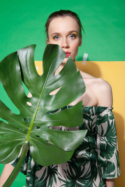 Young woman in summer dress holding leaf - Fotografie, Obrázek