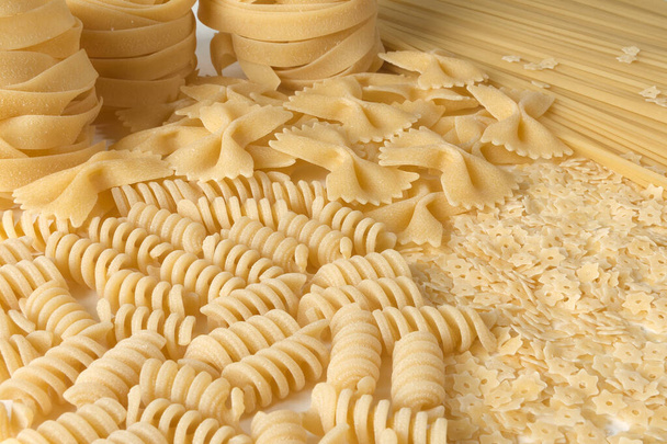 Types of Italian pasta: fusilli, farfalle, fettuccine, spaghetti, stars. - Photo, Image