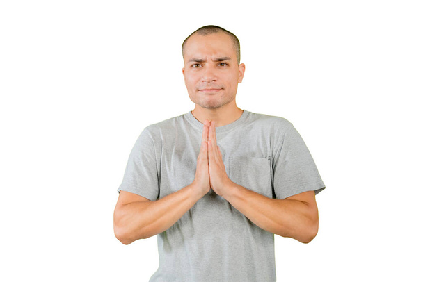 Close up of Caucasian young man doing yoga exercise while sitting in the studio. Isolated on white background - 写真・画像