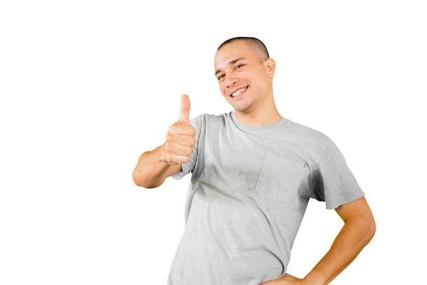 Picture of Caucasian man smiling at the camera while showing thumb up and standing in the studio. Isolated on white background - Фото, зображення