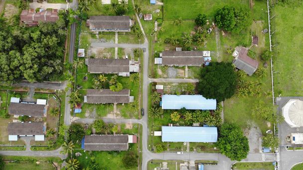 An aerial view of buildings surrounded by fresh greenery - Photo, Image