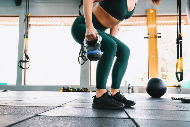 White sportswoman doing workout with dumbbell in gym - Valokuva, kuva