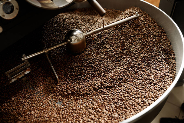 Coffee processing. Roastery, roasting machine and fresh beans - Фото, изображение