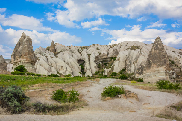 Amazing Volcanic rock formations known as Love Valley or Fairy Chimneys in Cappadocia, Turkey. Mushroom Valley one of attractions in Goreme National Park, Turkey. Mountains with rooms inside - Foto, Bild