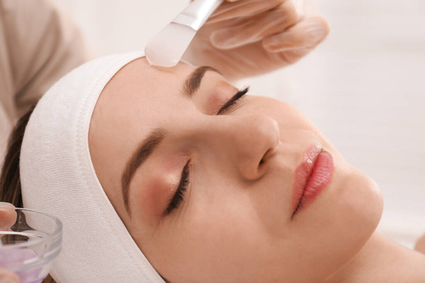 Young woman during face peeling procedure in salon, closeup - Fotografie, Obrázek