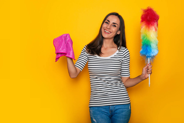 Happy young cute girl in casual wear is posing with some equipment and supply for house cleaning  - Zdjęcie, obraz