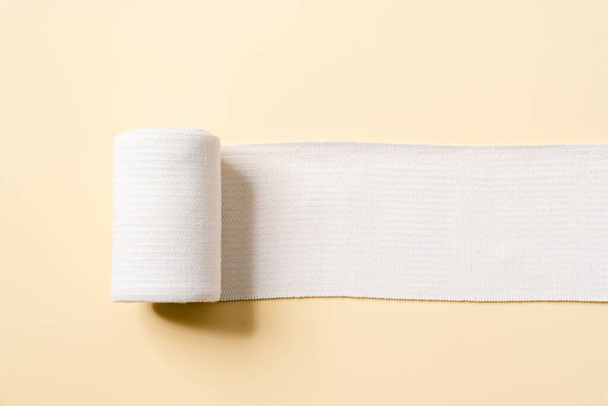 Overhead view of the unfolded bandage in the beige studio - Valokuva, kuva